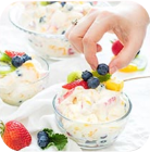 putting berries to ice-cream in bowl